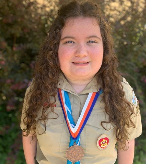 Picture of Sierra from Troop 2220 wearing her Thomas Edison STEM Super Nova award medal.